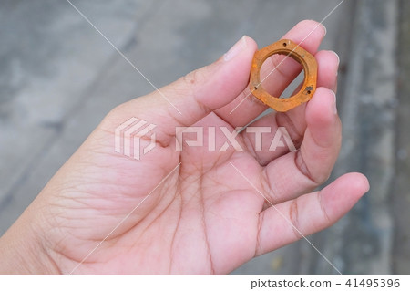 Hand Holding A Piece of Rustic Hex Nut Hand Holding A Piece of Rustic Hex Nut 41495396