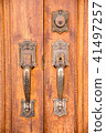 Vintage brass door handle with lock on wooden door 41497257