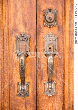 Vintage brass door handle with lock on wooden door Vintage brass door handle with lock on wooden door 41497257