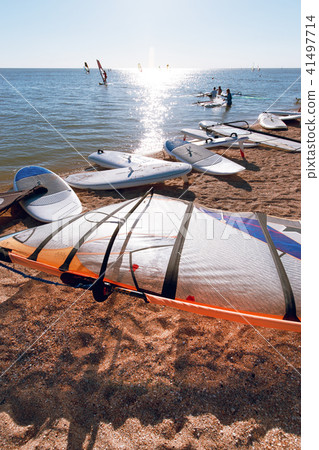 Windsurf boards on the sand at the beach. Windsurfing and active lifestyle Windsurf boards on the sand at the beach. Windsurfing and active lifestyle 41497714