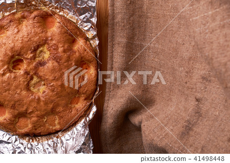 Apricot cake baked in foil on a wooden table Apricot cake baked in foil on a wooden table 41498448
