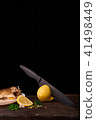 Cutted lemonwith black knife  41498449