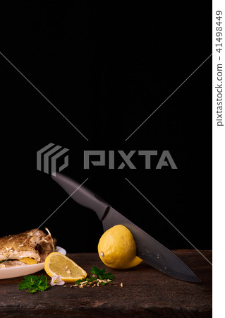 Cutted lemonwith black knife Cutted lemonwith black knife 41498449