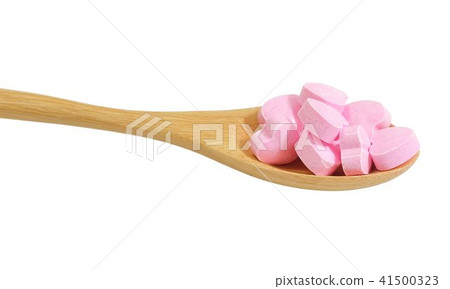 Wooden Spoon Full with Vitamins C on White 41500323