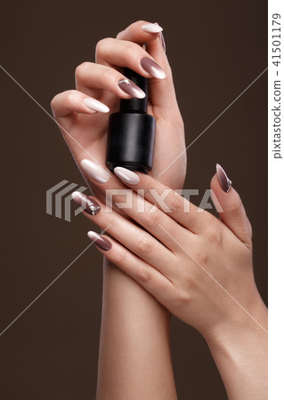 Beautiful classic manicure on female hand with nail polish . Close-up. Beautiful classic manicure on female hand with nail polish . Close-up. 41501179
