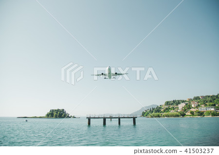 the plane is landing to the airport of Corfu at summer day 41503237