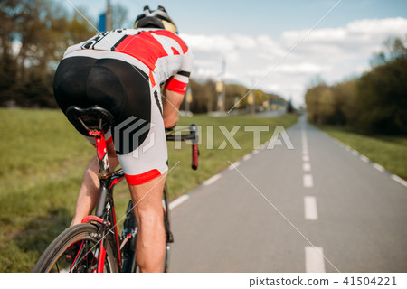 Cyclist on bike path, view from the rear wheel 41504221