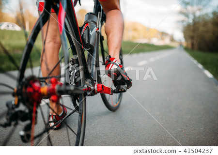 Bycyclist on bike path, view from the rear wheel 41504237