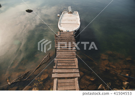 boat is on the river near the wooden bridge 41504553