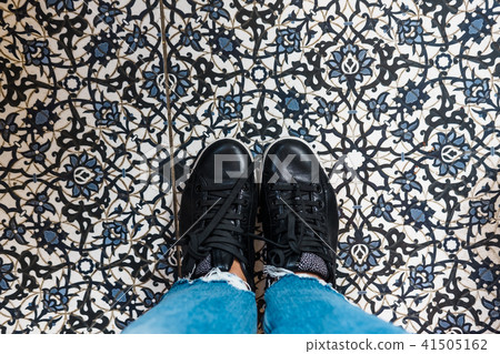 Woman's shoes on moroccan tile floor Woman's shoes on moroccan tile floor 41505162