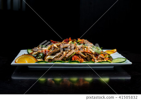 Chinese cuisine, boiled beef with cucumber and tomato in white plate, on black background 41505832