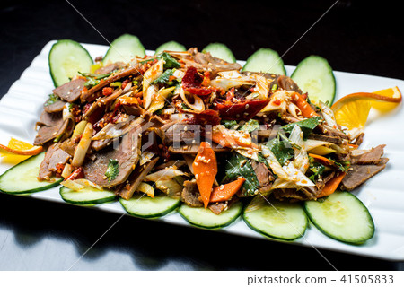 Chinese cuisine, boiled beef with cucumber and tomato in white plate, on black background Chinese cuisine, boiled beef with cucumber and tomato in white plate, on black background 41505833
