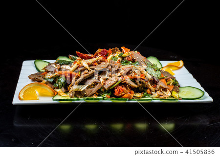 Chinese cuisine, boiled beef with cucumber and tomato in white plate, on black background 41505836