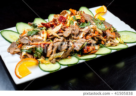 Chinese cuisine, boiled beef with cucumber and tomato in white plate, on black background Chinese cuisine, boiled beef with cucumber and tomato in white plate, on black background 41505838