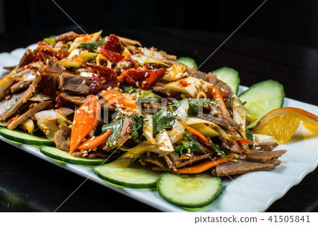 Chinese cuisine, boiled beef with cucumber and tomato in white plate, on black background 41505841