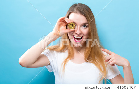 Woman holding a physical bitcoin 41508407