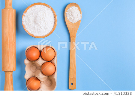 Ingredients for baking on a blue background. Ingredients for baking on a blue background. 41513328