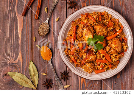 Pilaf (biryani) on a wooden background Pilaf (biryani) on a wooden background 41513362