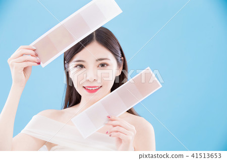 woman holding skin color scale woman holding skin color scale 41513653