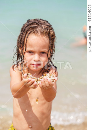 Little boy got pebbles into the hands Little boy got pebbles into the hands 41514003