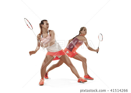 Young women playing badminton over white background 41514266