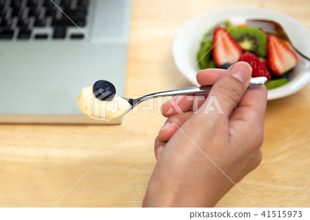Man eating yogurt with blueberry  41515973