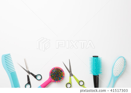 Photo of combs and scissors isolated on white background. 41517303