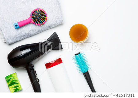 Photo of hair dryer, comb, scissors, towels, soaps isolated on white background. 41517311