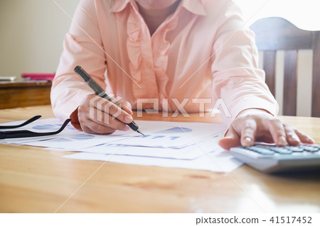Asian Business woman hand pointing at document 41517452