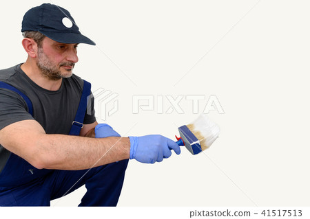 Painter paints the wall with the tint of white. Painter paints the wall with the tint of white. 41517513