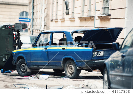 car destroyed by protesters during riot. Police car destroyed near police department, city center car destroyed by protesters during riot. Police car destroyed near police department, city center 41517598