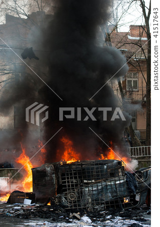 burning car. car destroyed and set on fire during the riots. city center burning car. car destroyed and set on fire during the riots. city center 41517643