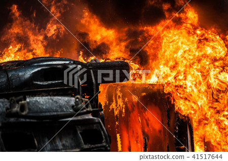 burning car. car destroyed and set on fire during the riots. city center 41517644