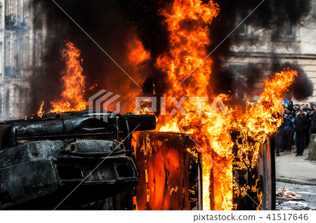 burning car. car destroyed and set on fire during the riots. city center 41517646