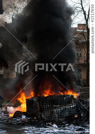 burning car. car destroyed and set on fire during the riots. city center burning car. car destroyed and set on fire during the riots. city center 41517650