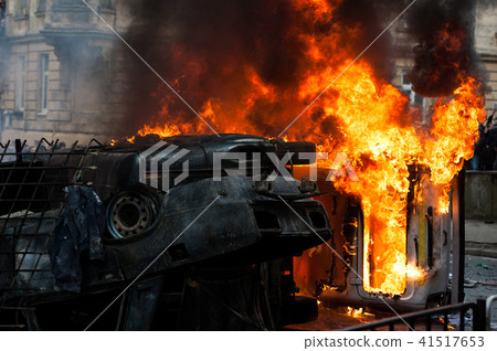 burning car. car destroyed and set on fire during the riots. city center burning car. car destroyed and set on fire during the riots. city center 41517653