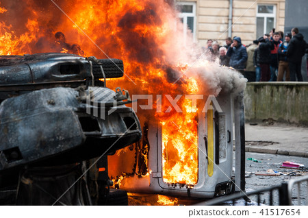 burning car. car destroyed and set on fire during the riots. city center burning car. car destroyed and set on fire during the riots. city center 41517654