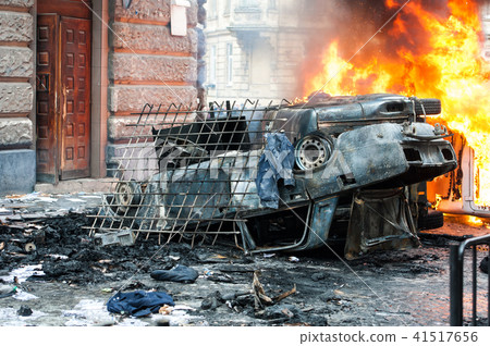 burning car. car destroyed and set on fire during the riots. city center burning car. car destroyed and set on fire during the riots. city center 41517656