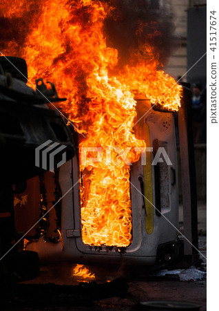 burning car. car destroyed and set on fire during the riots. city center 41517674