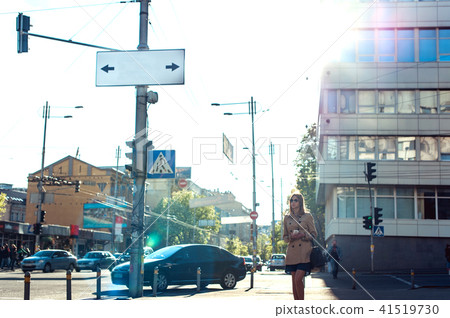 Young business woman walking along the street Young business woman walking along the street 41519730