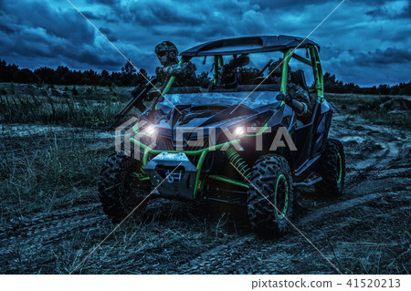 Army rangers moving on military buggy at night 41520213