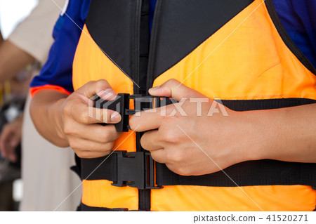 Young traveler putting on a life jacket for saefty 41520271