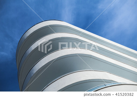 White concrete facade under blue cloudy sky 41520382