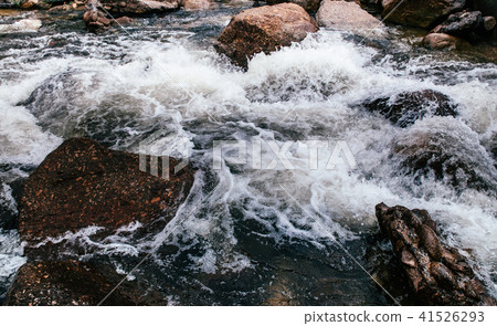 Tropical river flowing rapid water rocks landscape 41526293