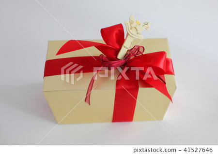Beige square gift box with red bow on white background 41527646