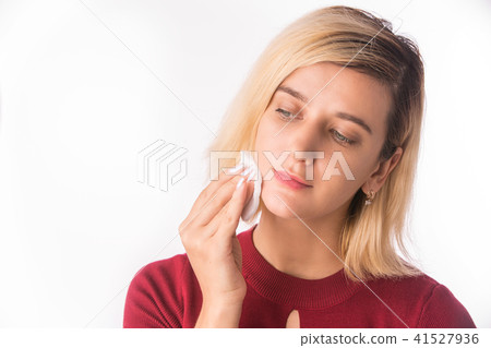 Woman Cleaning Face with white cotton pad. Woman Cleaning Face with white cotton pad. 41527936