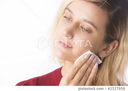 Woman Cleaning Face with white cotton pad. Woman Cleaning Face with white cotton pad. 41527938