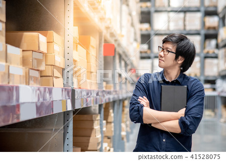 Asian worker man doing stocktaking in warehouse Asian worker man doing stocktaking in warehouse 41528075