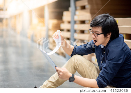 Asian worker man doing stocktaking in warehouse Asian worker man doing stocktaking in warehouse 41528086