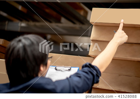 Asian worker man doing stocktaking in warehouse Asian worker man doing stocktaking in warehouse 41528088
